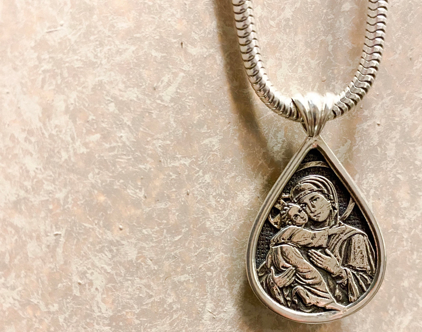 Saints of Christ Orthodox Christian Icon Jewelry - Sterling Silver Teardrop Icon pendant with recess oxidation of the Virgin Mary and Theotokos with Jesus Christ in her arms. Available in other shapes, sizes, and materials. 