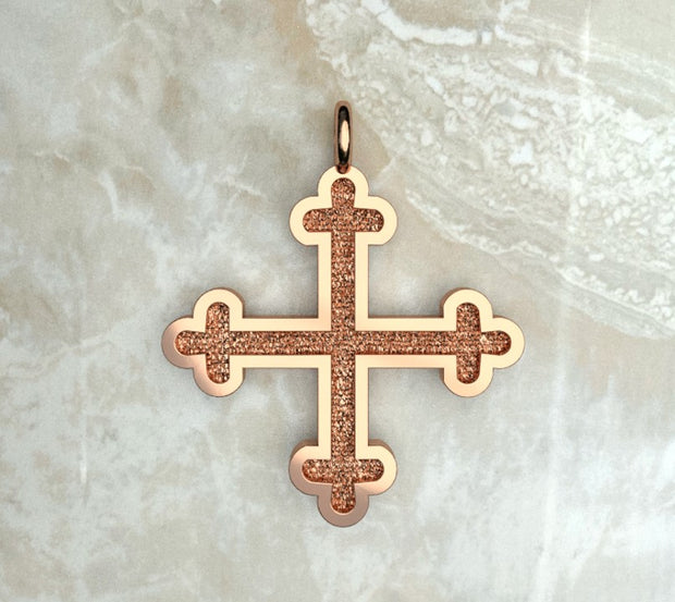 Rose gold or rose gold plated three budded Greek cross.