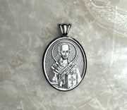 Saints of Christ Orthodox Icon Jewelry – Ovale (Oval- Shaped) pendant of the Saint John Chrysostom in silver, white gold, or rhodium plated brass. (Front Side)